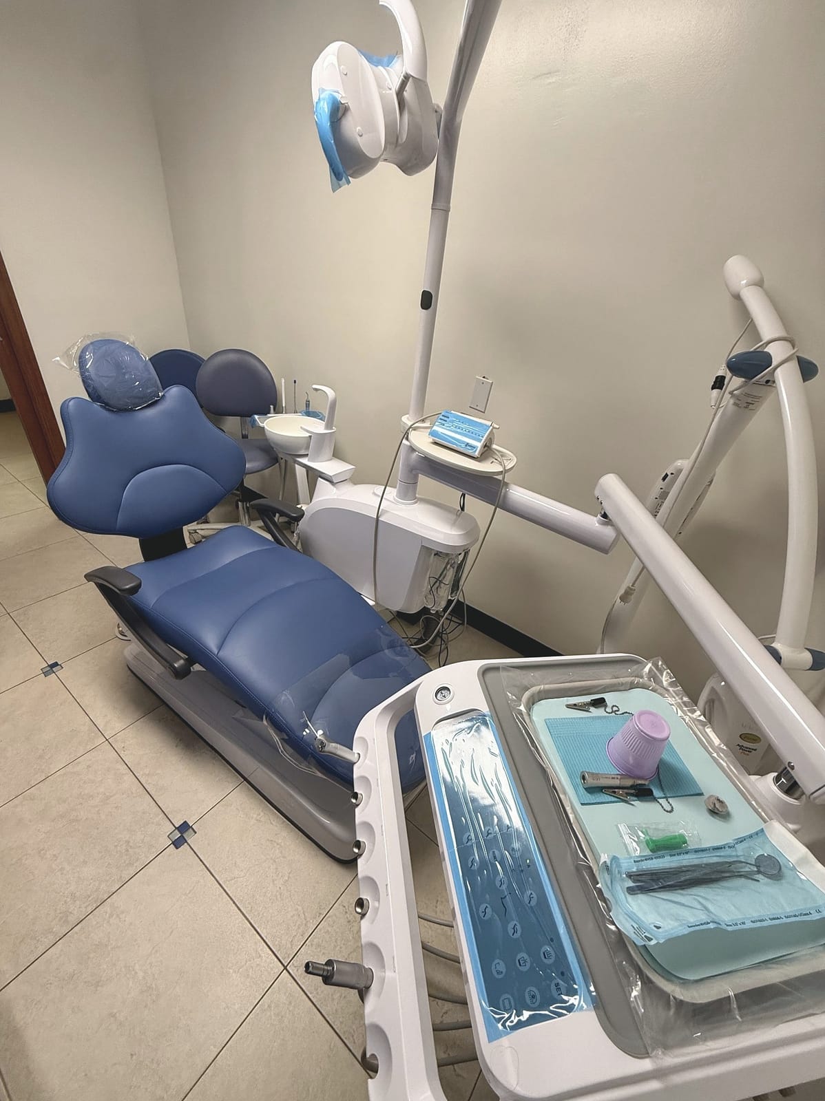 Treatment room at Rockaway Family Dentistry with a blue dental chair